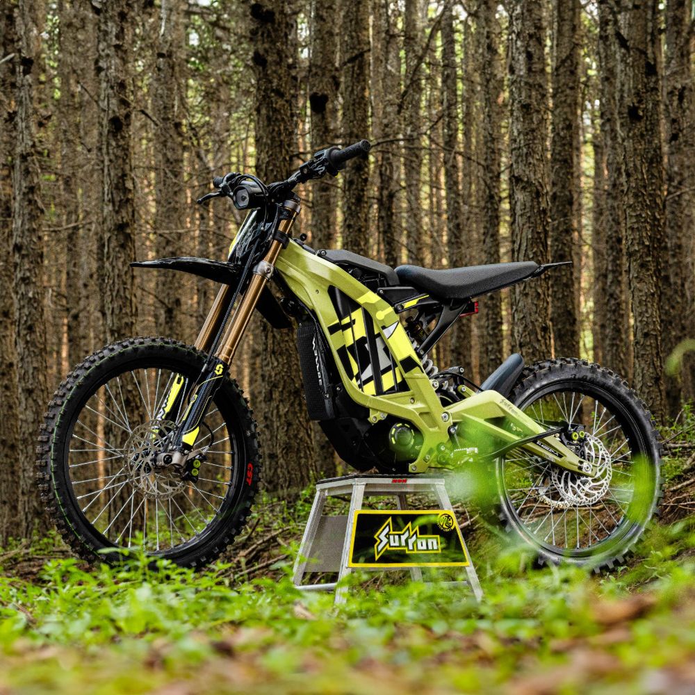 Surron Light Bee X electric dirt bike in forest trail lightweight off-road e-bike