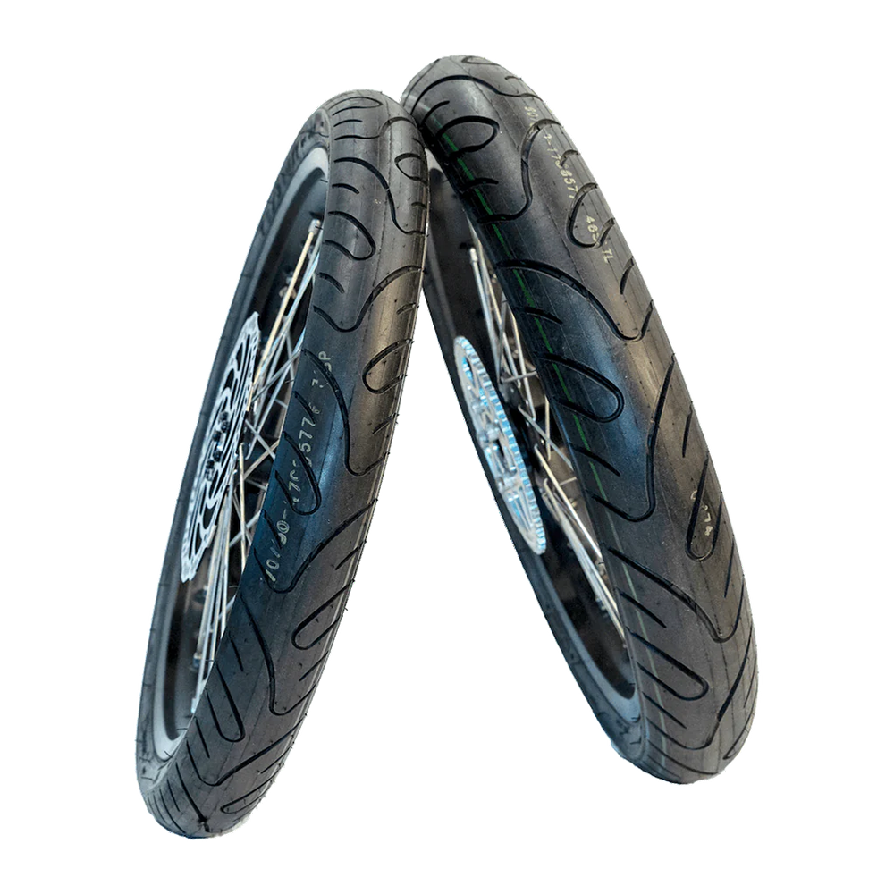 High-performance Sur Ron supermoto wheels featuring black spokes and road tires for enhanced grip and style