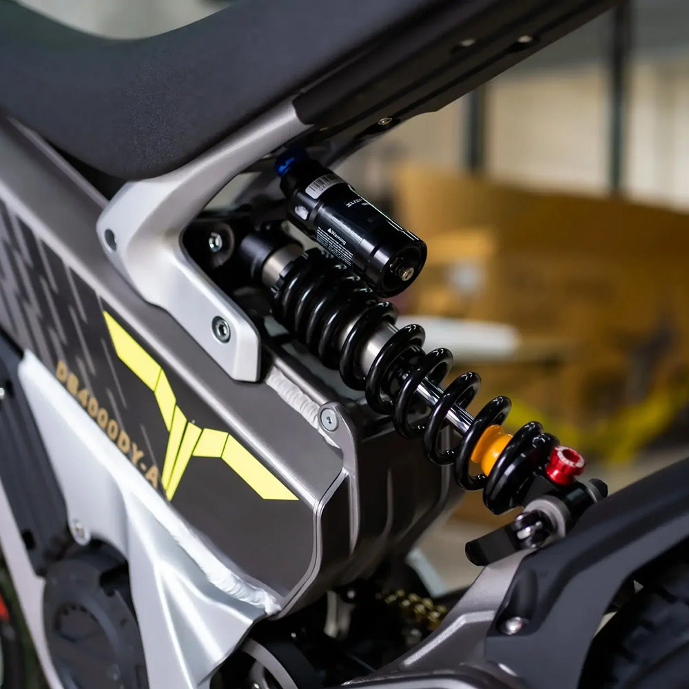 Talaria XXX electric dirt bike suspension system, highlighting advanced rear shock absorber for superior off-road riding comfort and control