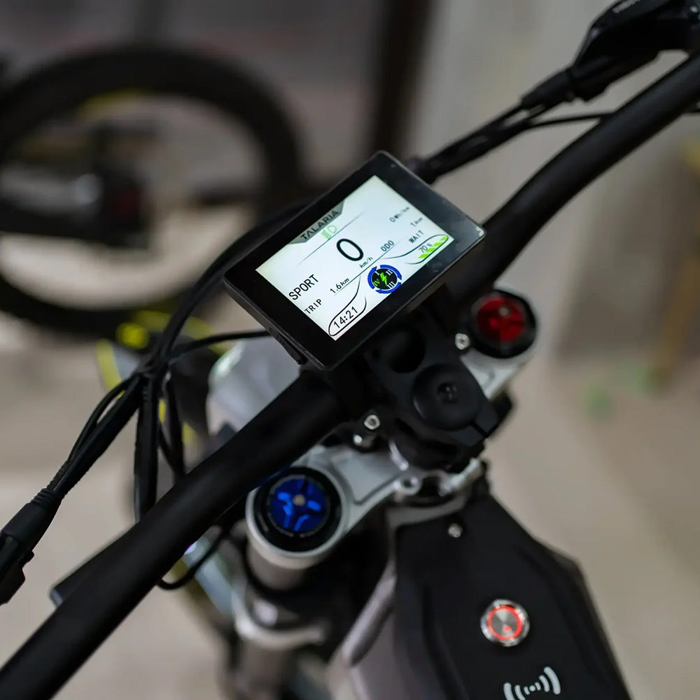 Talaria XXX electric dirt bike handlebar display showing speed, trip data, and sport mode, highlighting advanced dashboard technology