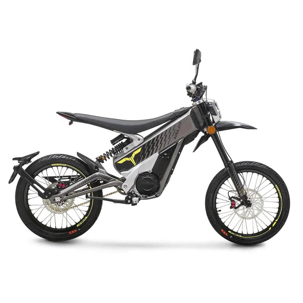 Side view of talaria x electric motorcycle, featuring a sleek frame, knobby tires, and a compact design suitable for off-road use