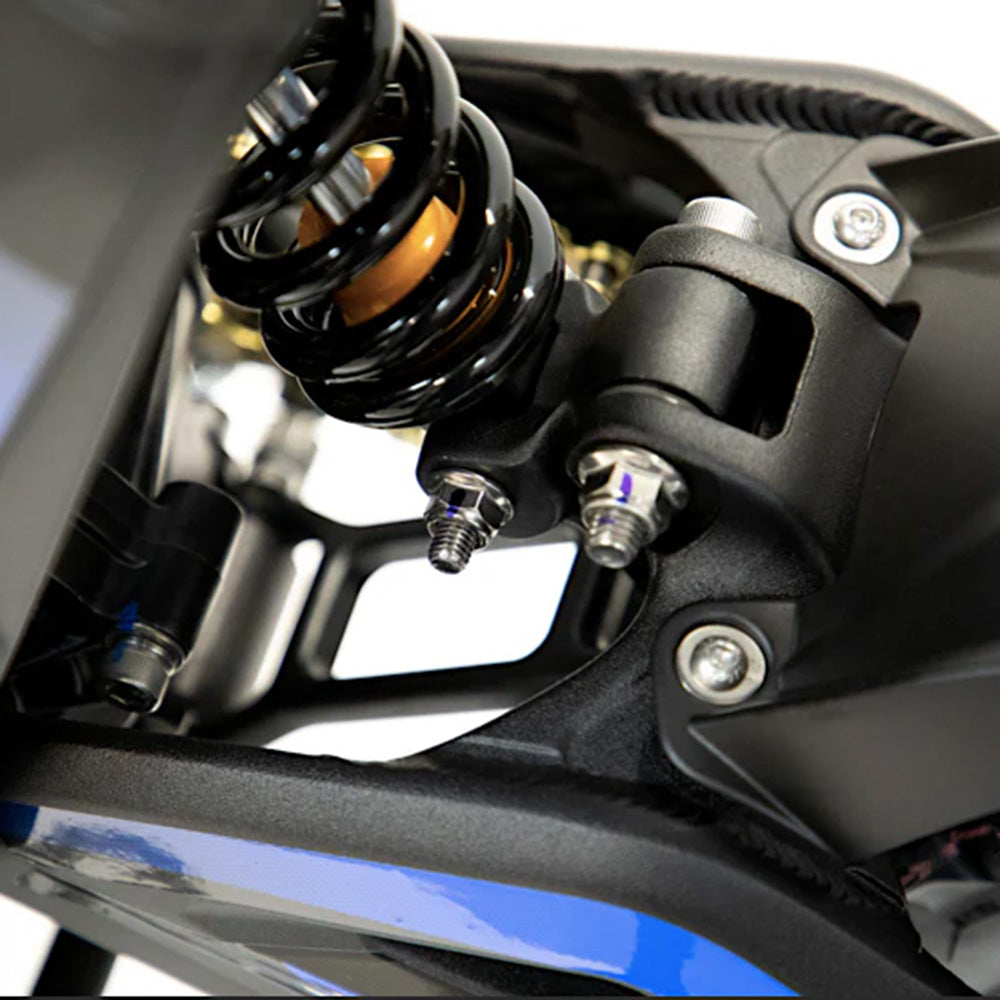 Close-up of the Talaria Sting R MX4’s rear suspension system, highlighting the robust shock absorber and precision-engineered components for enhanced off-road stability