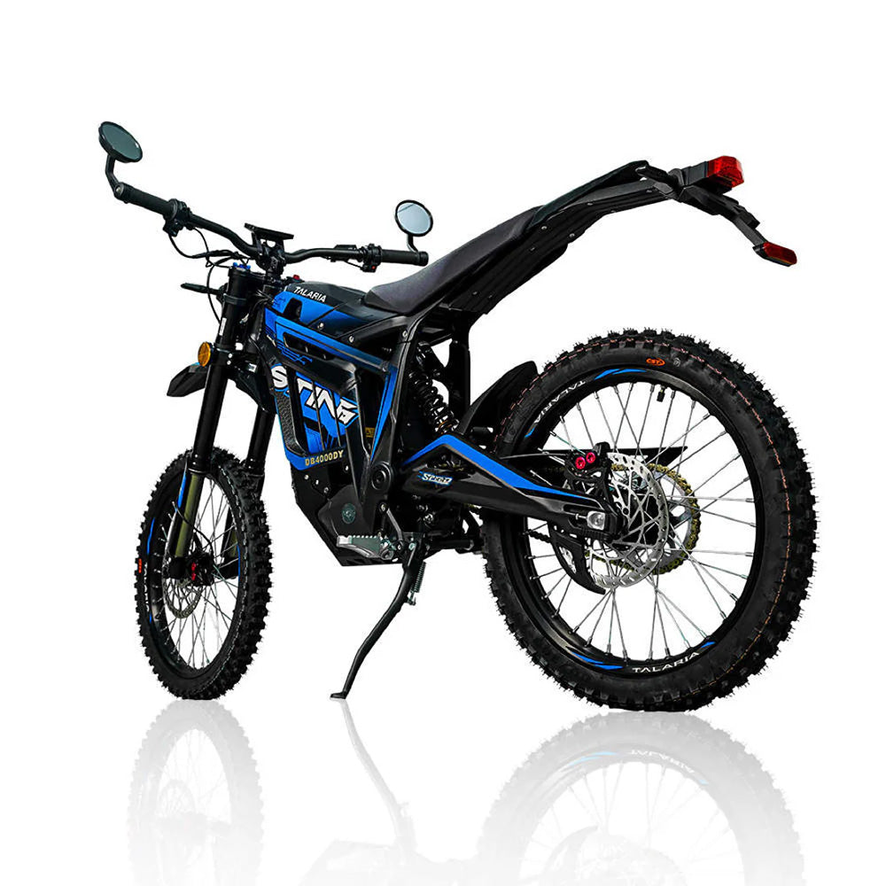 alaria Sting R MX4 illuminated in a dimly lit setting, showcasing its bold design, bright headlight, and off-road prowess